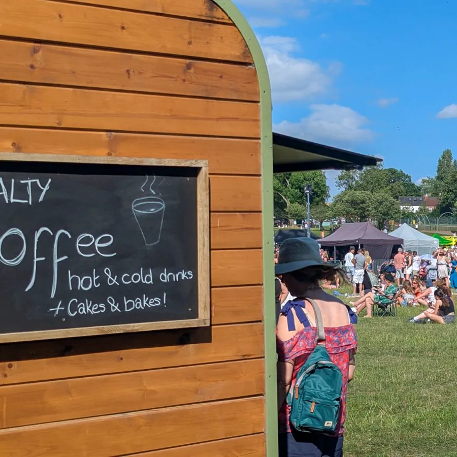 The side of the Gallop & Grind horsebox with its chalkboard menu at a busy outdoor event
